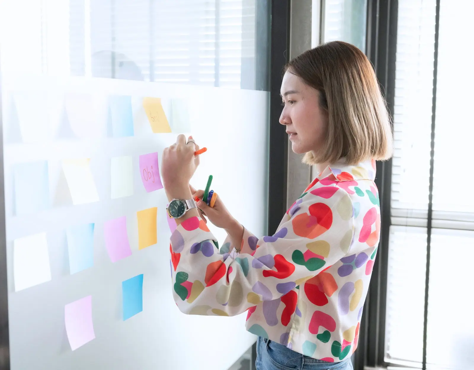 A colleague sorting ideas on sticky notes